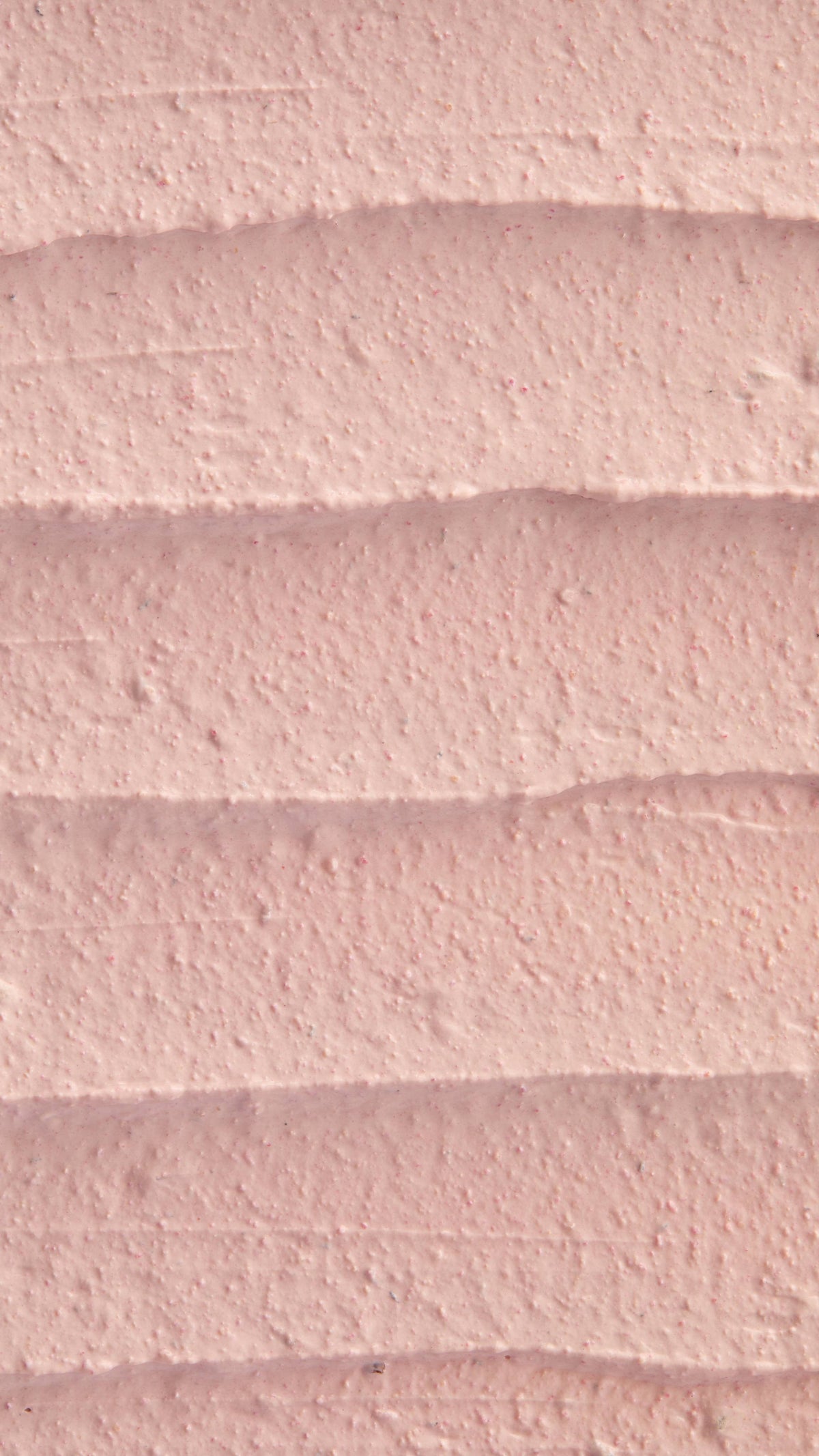 A super close-up image of the creamy, thick Mrs Whippy face mask product, focusing on the thick consistency of the flecks of finely blended fresh raspberries.